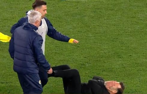 Jose Mourinho being helped up after an incident on the field.