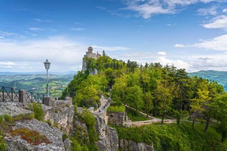 Medieval tower on a cliff overlooking a valley.