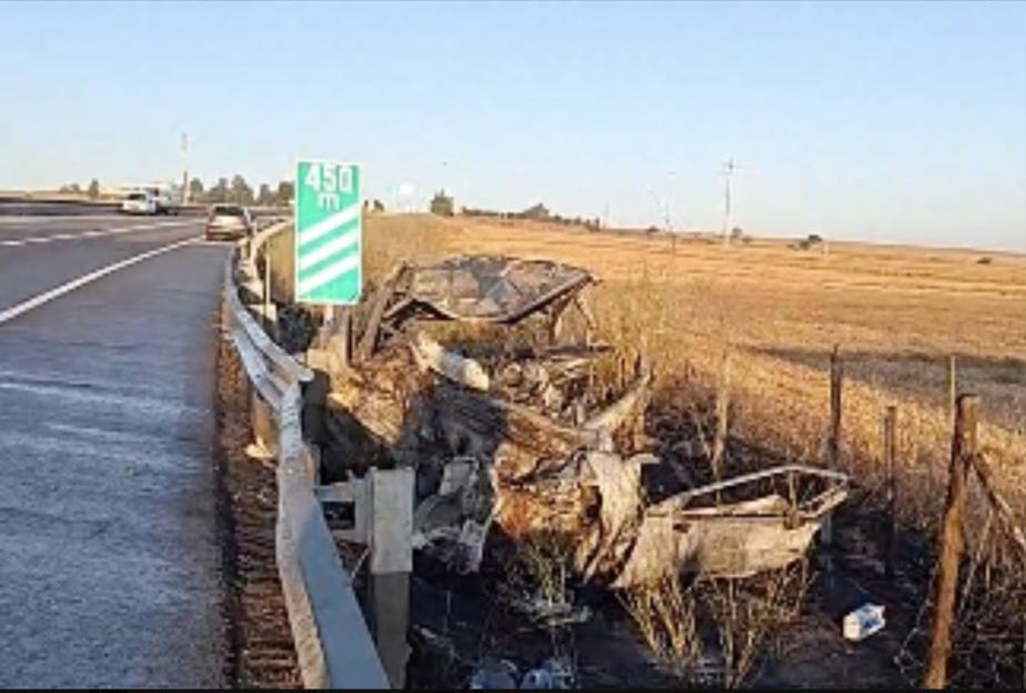 Burned-out car after fatal head-on collision.