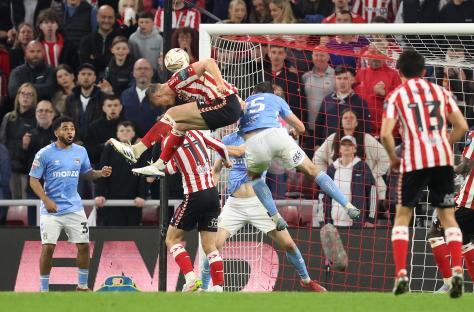 A soccer player scoring a goal.