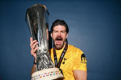 Fraser Forster of Tottenham Hotspur holding the UEFA Europa League trophy.