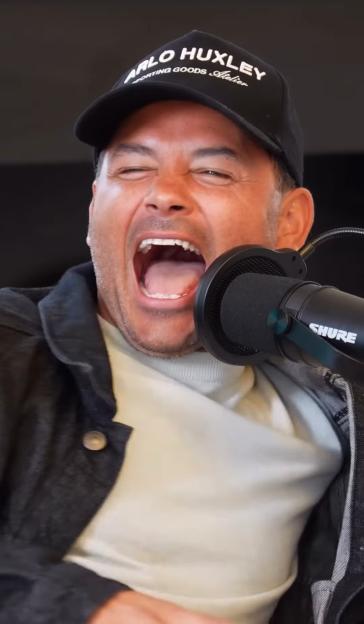 Ryan Thomas speaking into a microphone.