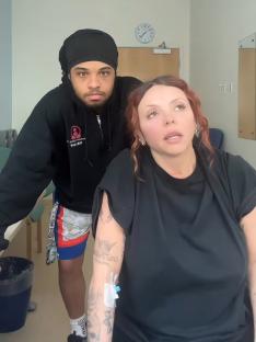 Jesy Nelson in a hospital room with a man, receiving medical treatment.