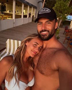 Millie Court and Liam Reardon embracing in the Maldives.
