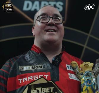 Stephen Bunting holding a darts trophy.