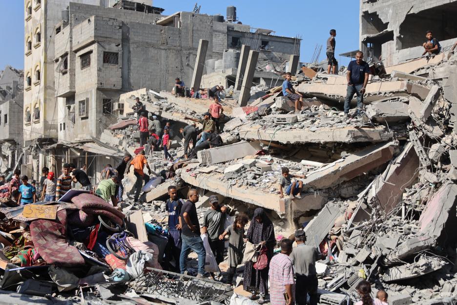 People search through the rubble of a destroyed building in Gaza City.