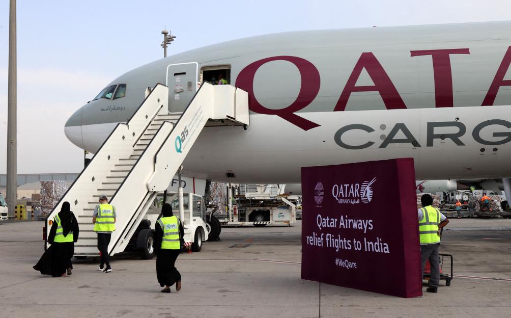 Workers load 300 tonnes of medical aid onto a Qatar Airways cargo plane at Hamad International Airport, for relief flights to India.