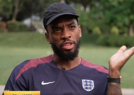 Man in England jersey speaking.
