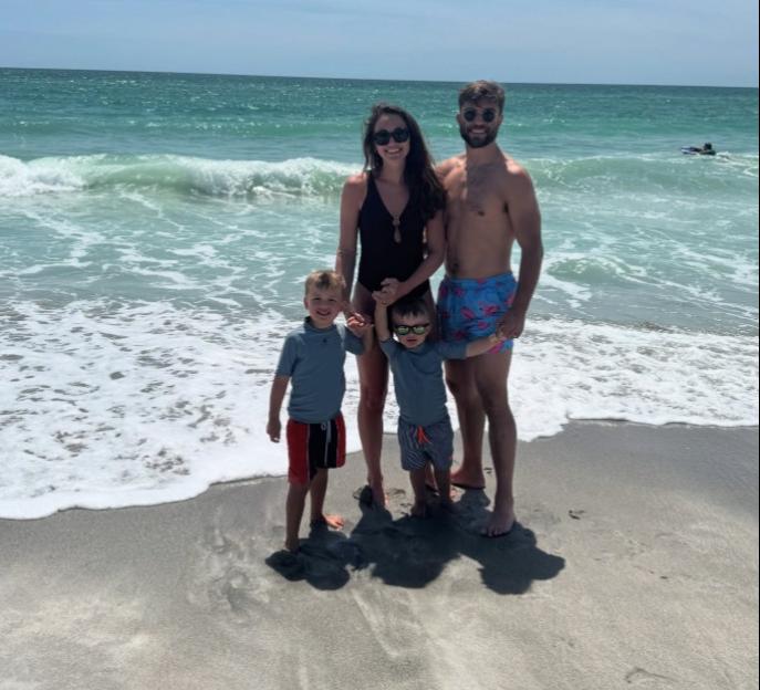 Family of four on a beach.