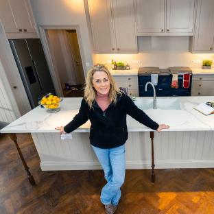 Sarah Beeny standing in her new kitchen.