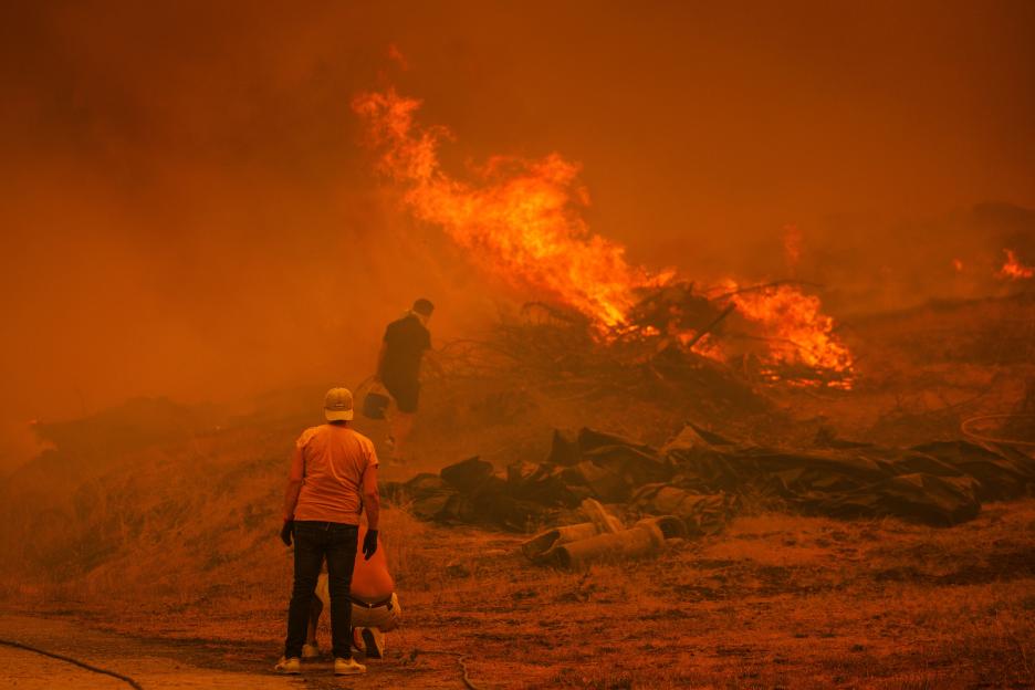 People watching a large wildfire.