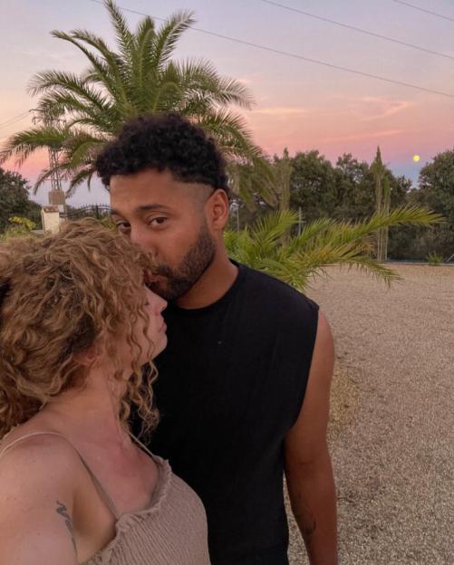 Couple embracing at sunset.