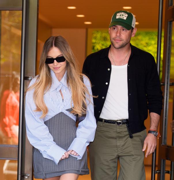 Sydney Sweeney and Scooter Braun exiting a building.