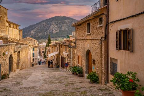 Stone stairway in Pollenca, Majorca, leading uphill towards a mountain.