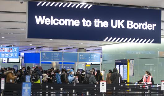 Passengers queueing at UK border control.