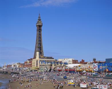 Crowded Blackpool beach with the Blackpool Tower in the background.