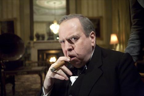 Timothy Spall in The King's Speech, smoking a cigar.