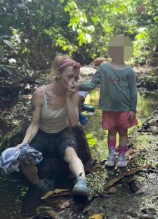 Hannah Spearritt with her child by a stream in Costa Rica.