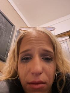 Close-up of a crying woman with blonde hair.