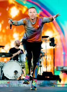 Chris Martin of Coldplay performing on stage.