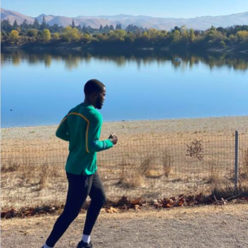 Man jogging next to a lake.