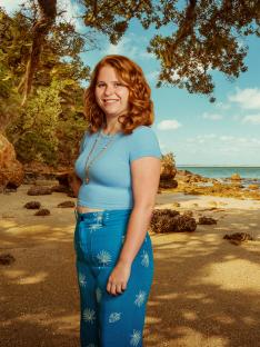 Woman standing on a beach.