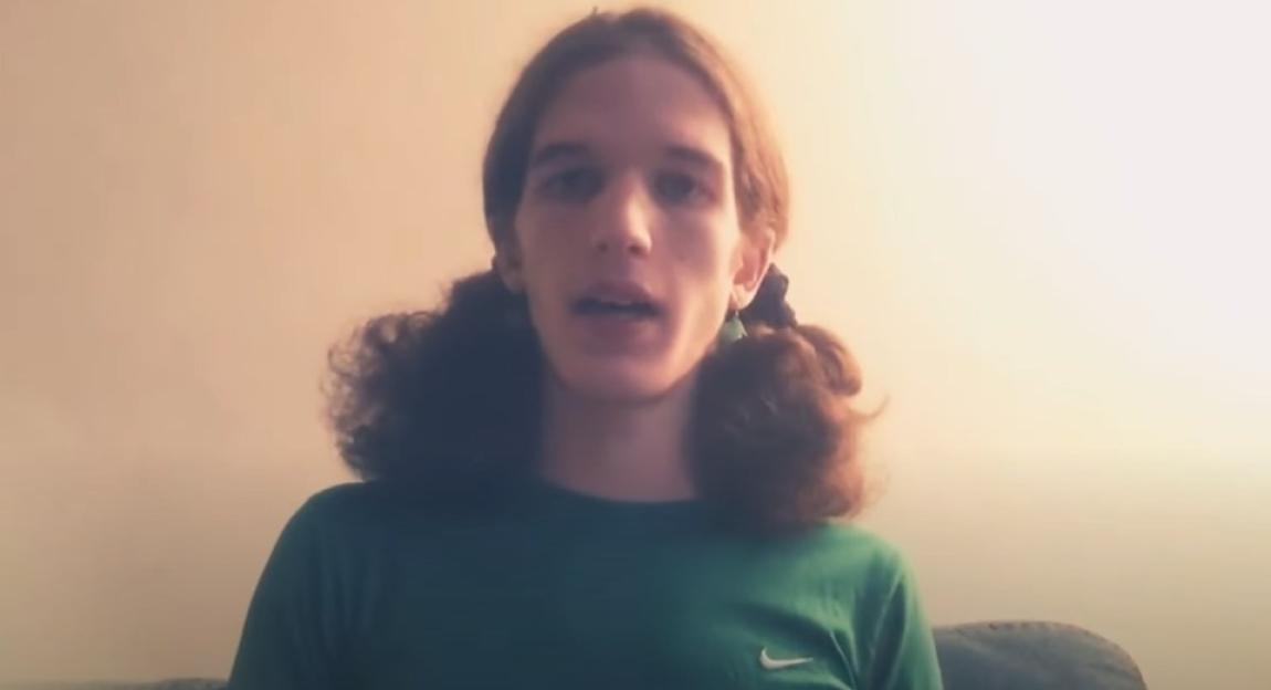Person with long brown hair in pigtails speaking to the camera.