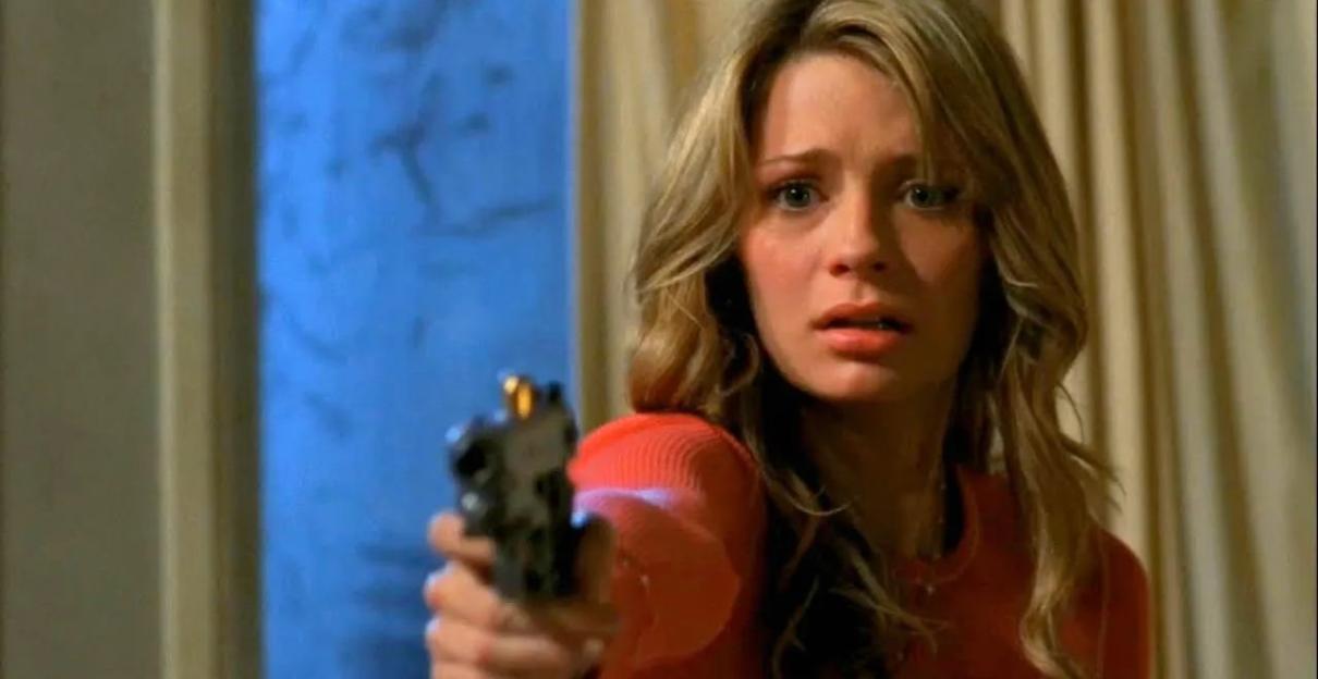 Micha Barton as Marissa in The O.C. holding a gun.
