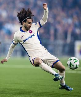 Marc Cucurella of Chelsea kicking a soccer ball.