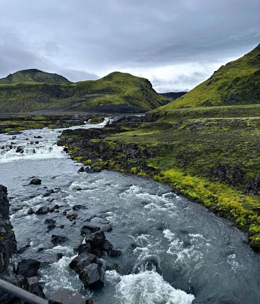 River flowing through mossy Icelandic landscape.