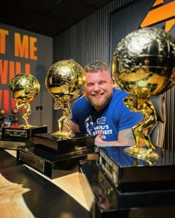Tom Stoltman, World's Strongest Man 2024, with his trophies.