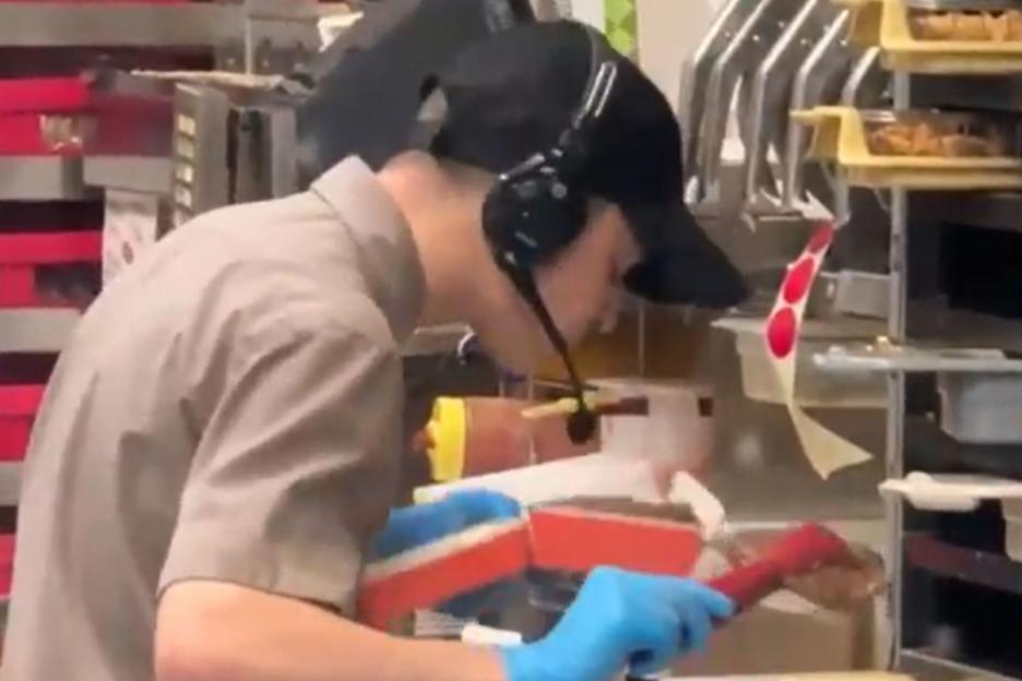 Stomach-churning moment fast food worker is caught SPITTING in burger at McDonald’s knock-off in covert video