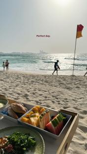Beach picnic with fruit and bread.