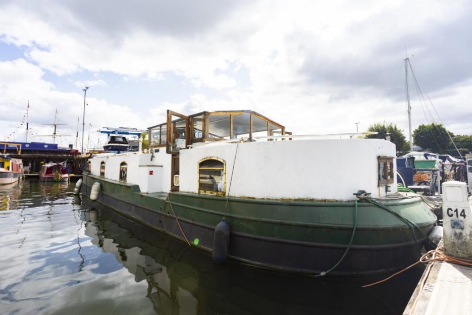 Houseboat docked at a marina.