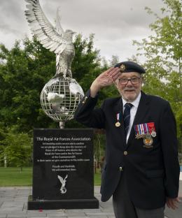 D-Day veteran saluting at the Royal Air Force Association memorial.