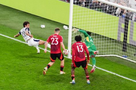 Luke Shaw scoring an own goal during a soccer match.