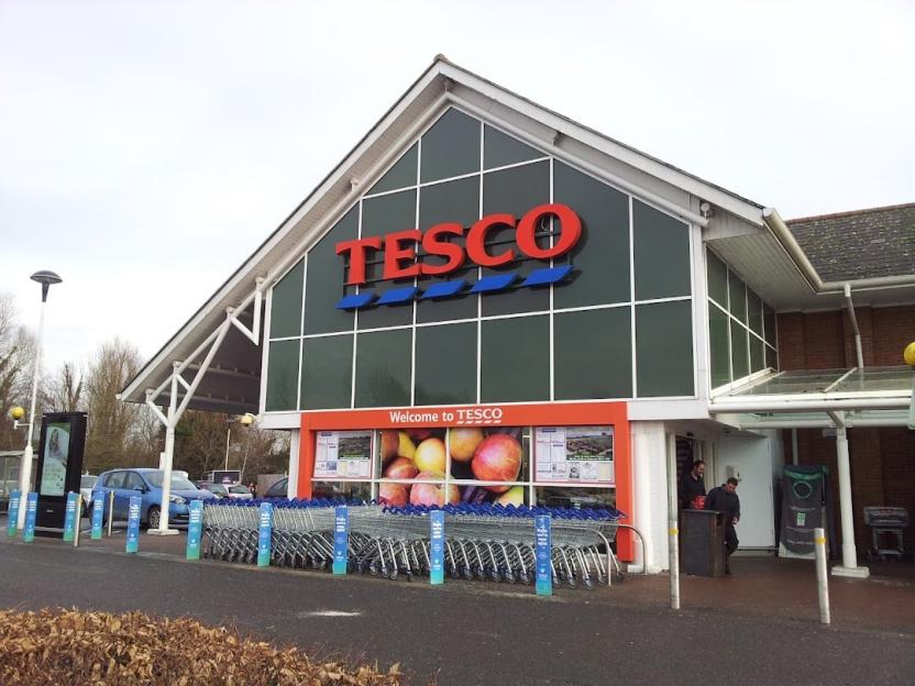 Tesco supermarket exterior with shopping carts.