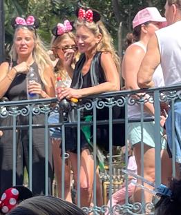 Kate Moss at Disney World wearing Minnie Mouse ears.