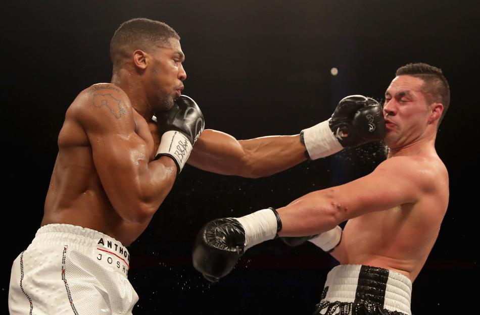 Anthony Joshua punching Joseph Parker during a boxing match.
