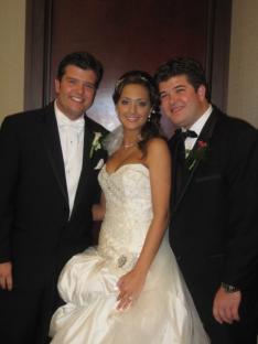Wedding photo of a bride and two groomsmen.