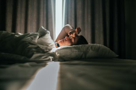 Woman waking up in bed.