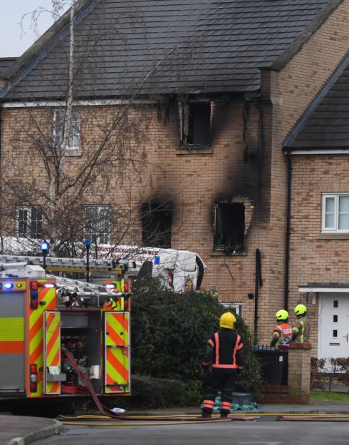 Firefighters at the scene of a house fire.