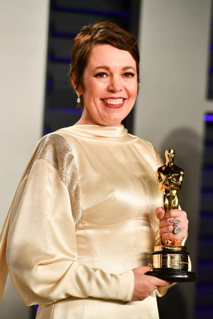 Olivia Colman holding an Oscar at the Vanity Fair Oscar Party.