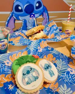 Stitch-themed treats: waffle sandwich, cookies, and drinks.
