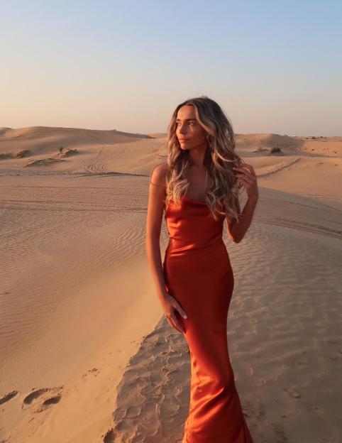 Woman in orange dress in the desert.