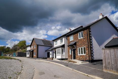 A row of new houses, still deserted and boarded up.