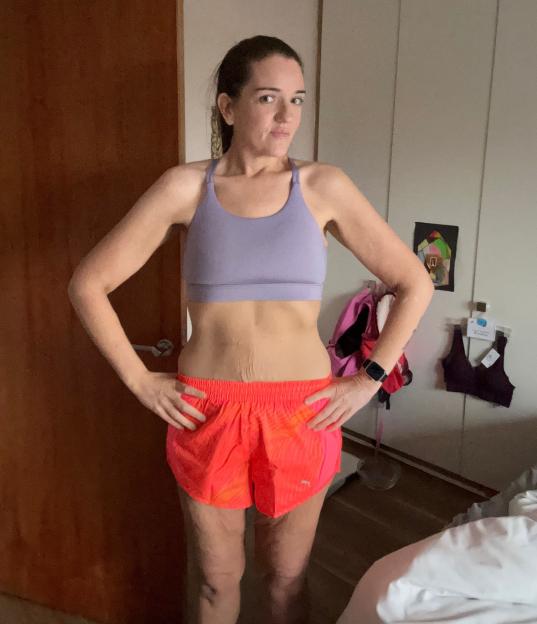 Woman in athletic wear after weight loss.