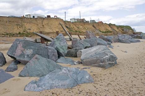 Large rocks placed on a beach to reduce coastal erosion.