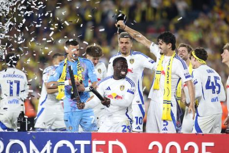Leeds United players celebrating with champagne and confetti.