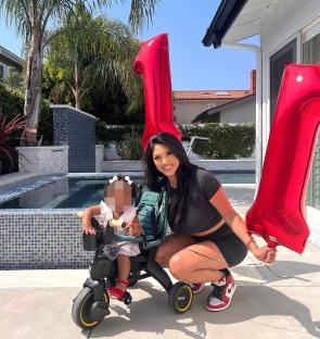 Woman and child with number one balloons.